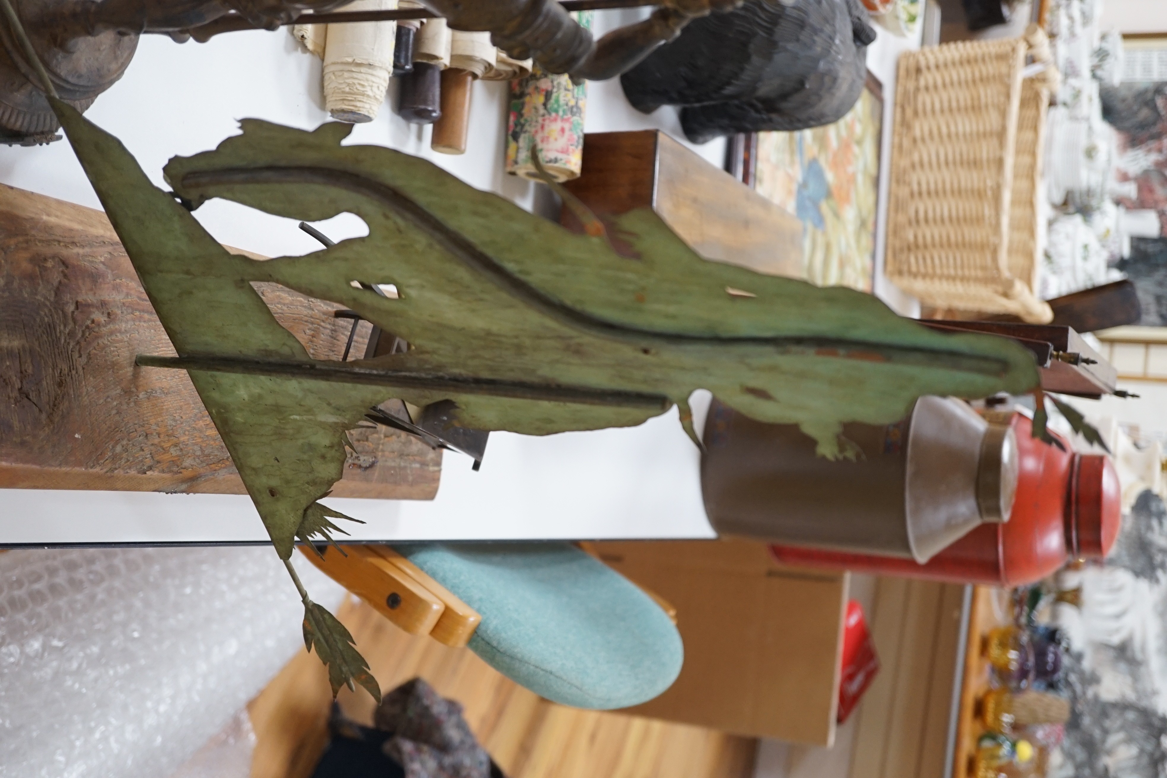 A spelter figural candlestick, a weather vane, a bronze wheel-barrel and a spade, Weather vane 51 cms high not including base